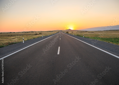 asphalt road with sunset © Daniel