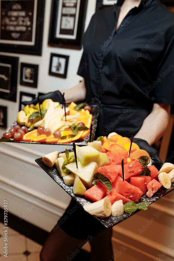 fruit platter wonderfully decorated fruits conceptual fruit platter shots in the waiter's hand luxury porcelain plate restaurant served buy fruit platter wonderfully decorated fruits conceptual fruit platter shots in the waiter's hand luxury porcelain plate restaurant served buy