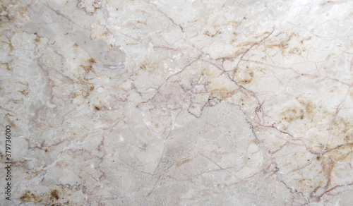 natural marble with beige and brown veins on a white background
