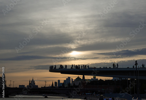 Flying bridge on the cityscape background: sunset hour