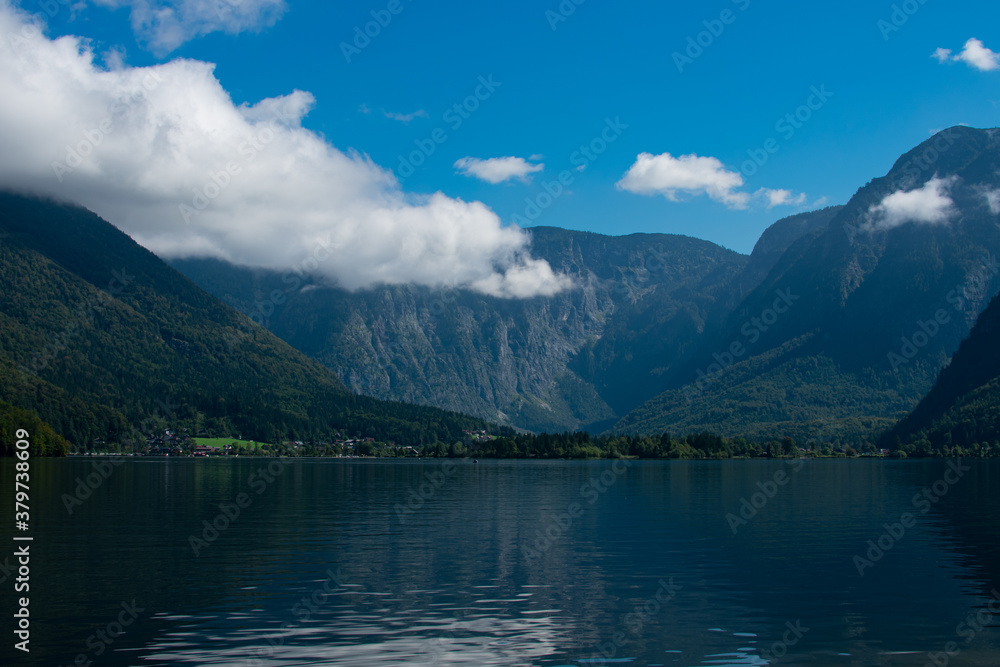 The beautiful Hallstätter See on a sunny autumn day with blue sky and clouds