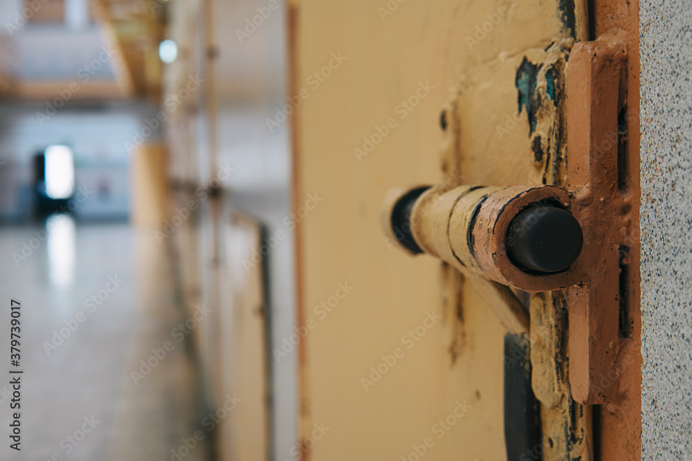 A closeup of the lock of a brick jail cell with the latch. Oldfashion