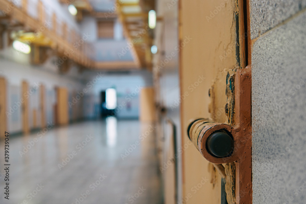 A closeup of the lock of a brick jail cell with the latch. Oldfashion