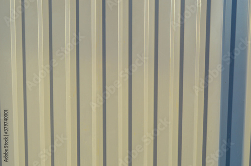 metallic gray ribbed texture. fence at the construction site. background for a photo shoot and flat lay. shiny flat surface for creative photography