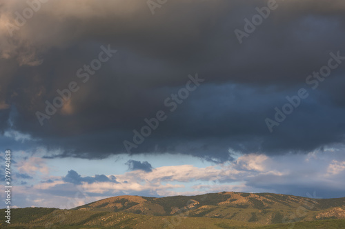 Gray storm clouds over the mountain. Autumn landscape before the rain. Dark blue terrible storm clouds. Bajdarsky valley. Crimea.