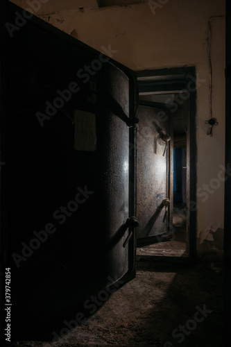 Opened heavy steel armored hermetic door in the Soviet bomb shelter photo