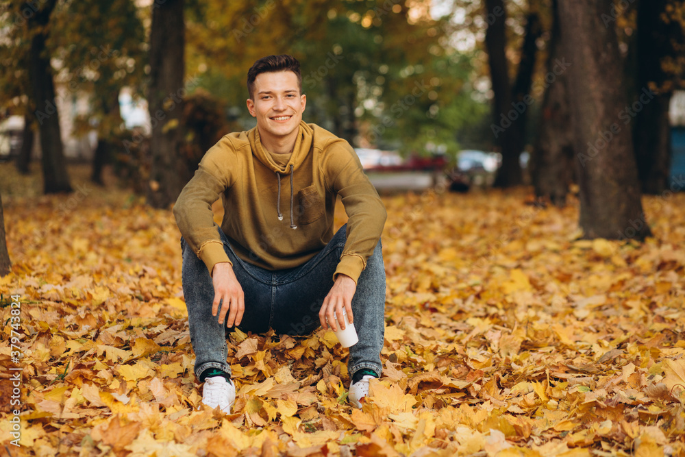 Portrait of handsome and happy boy smiling and dreaming in the autumn park Portrait of handsome and happy boy smiling and dreaming in the autumn park