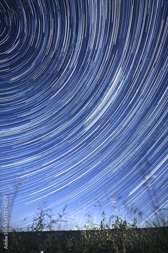 Concentric star tracks in the night sky. startrails. Vertical orientation.
