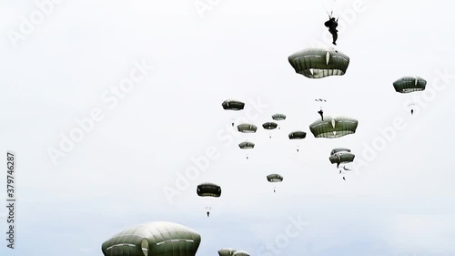 Paratroopers as they float down and land in a field near Sainte-Mere-Eglise, France for the 75th commemoration of D-Day, 2019
