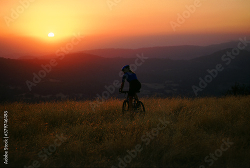 silhouette of a person riding a bike