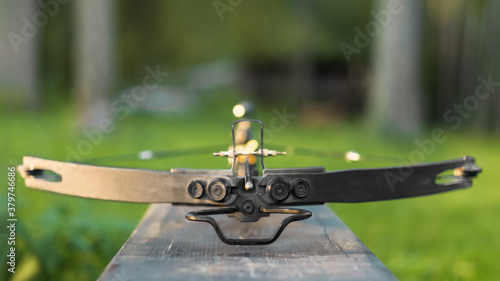 Canvas Print Loaded crossbow on a wooden bench. Selective focus.