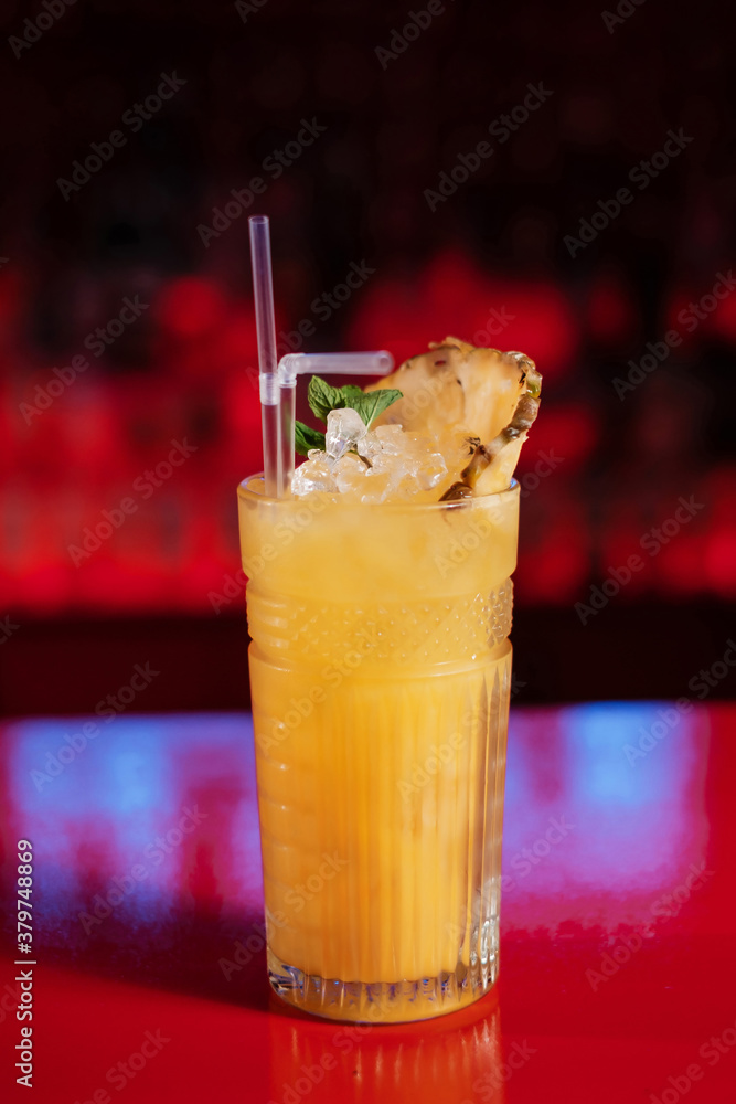 Exotic tropical cocktail with pineapple on the bar counter. Exotic tropical cocktail with pineapple on the bar counter.