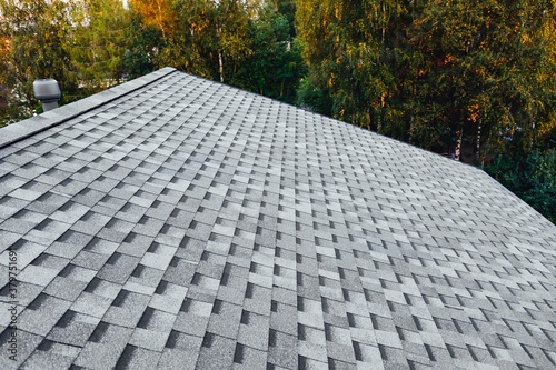 new renovated roof with shingles flat polymeric roof-tiles