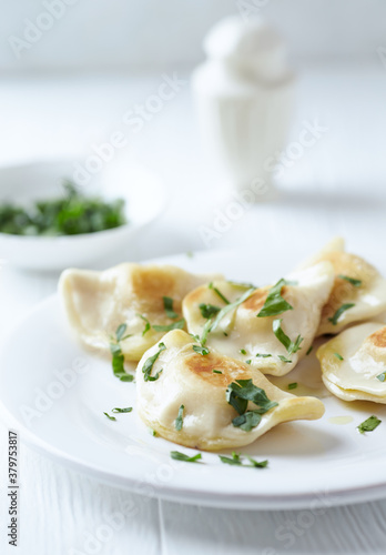 Dumplings with potato and cottage cheese stuffing (pierogi). Traditional Polish Christmas Dinner. Bright background.	