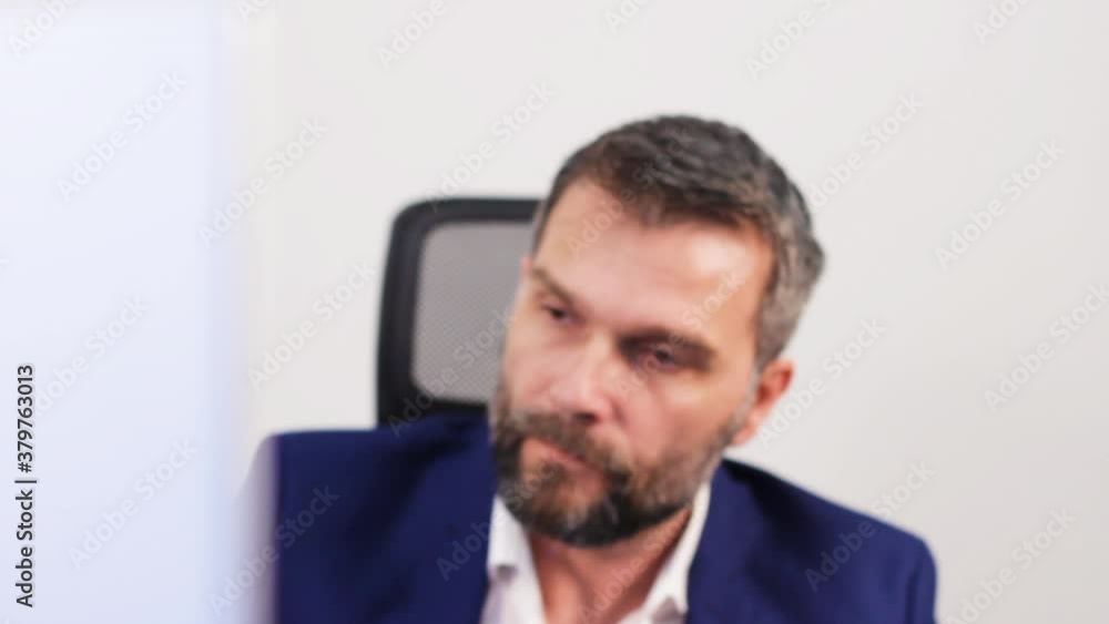 Nervous Investment Banker in Office Looking at Computer Screen With Stock Prices Picking Up Phone. Close Up Static Full Frame Nervous Investment Banker in Office Looking at Computer Screen With Stock Prices Picking Up Phone. Close Up Static Full Frame