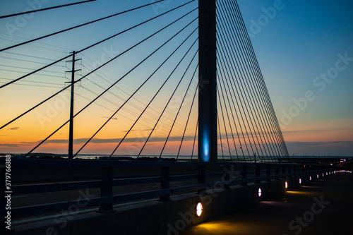 steel bridge over waterway evening sky