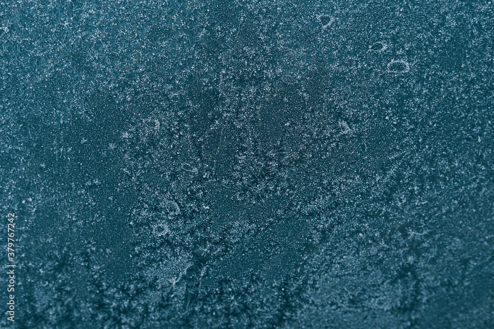 Winter ice texture on the frozen window. Christmas or New year background. Type of glass at low temperatures. Winter ice texture on the frozen window. Christmas or New year background. Type of glass at low temperatures.