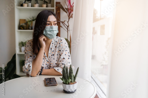woman wearing face mask for protection coronavirus (covid-19) in cafe