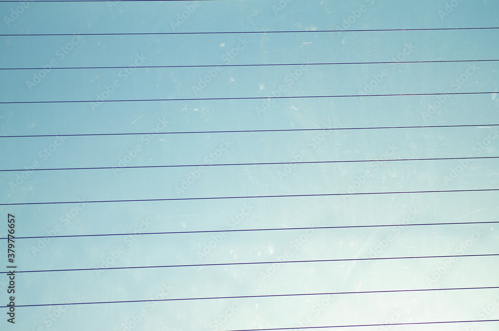 Thin dark lines on a background of blue sky. Thin dark lines on a background of blue sky.