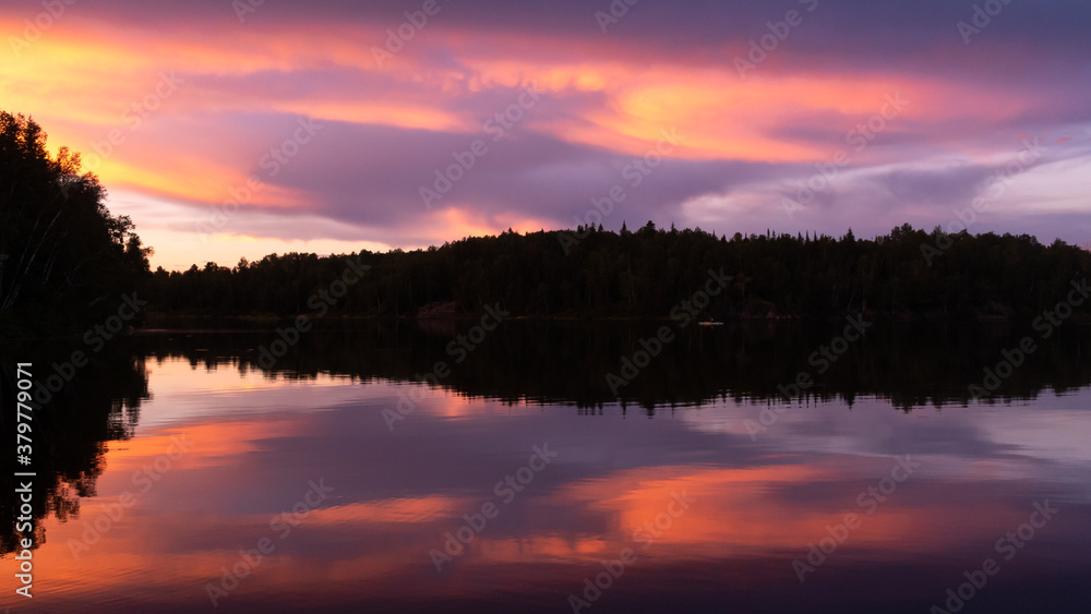 Beautiful  sunset reflecting in a lake in Quebec, Canada 