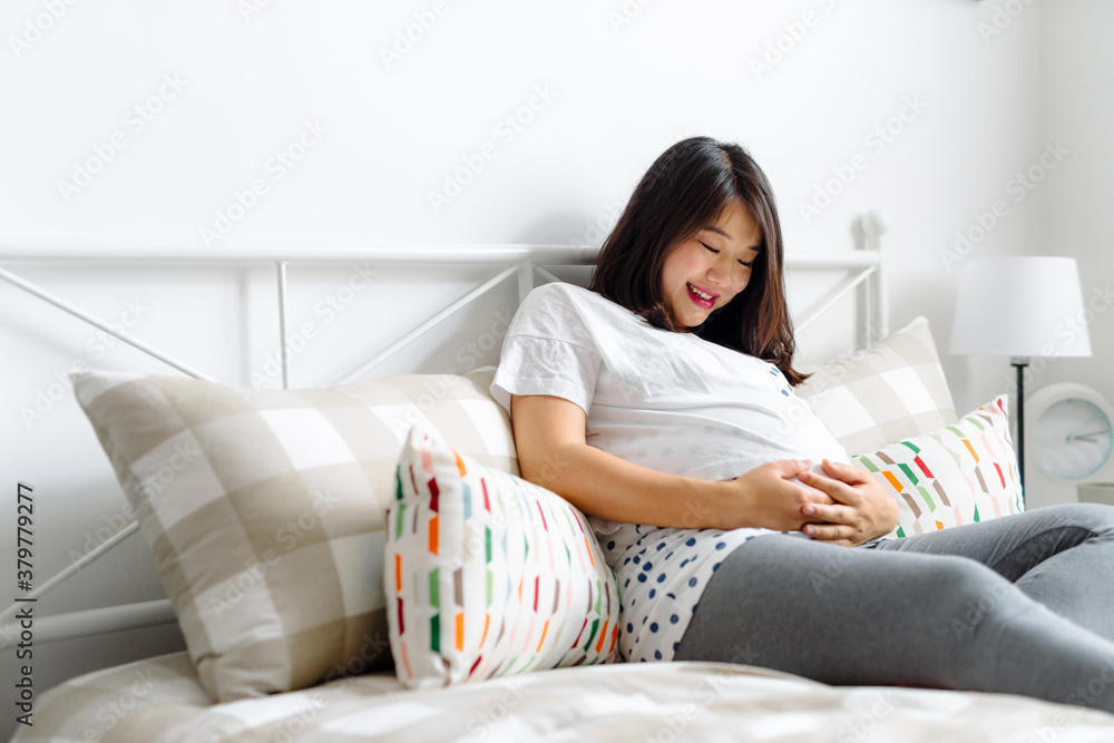 Pregnant woman having a rest on bed