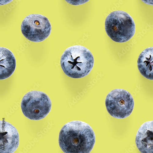 Trendy seamless pattern of blueberries. Blueberry pattern isolated on green background.