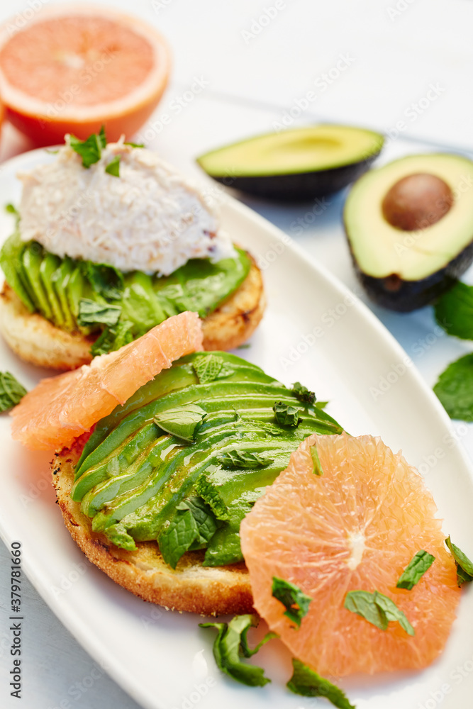 Gourmet breakfast bagel with tuna fish, avocado, grapefruit, and mint Gourmet breakfast bagel with tuna fish, avocado, grapefruit, and mint