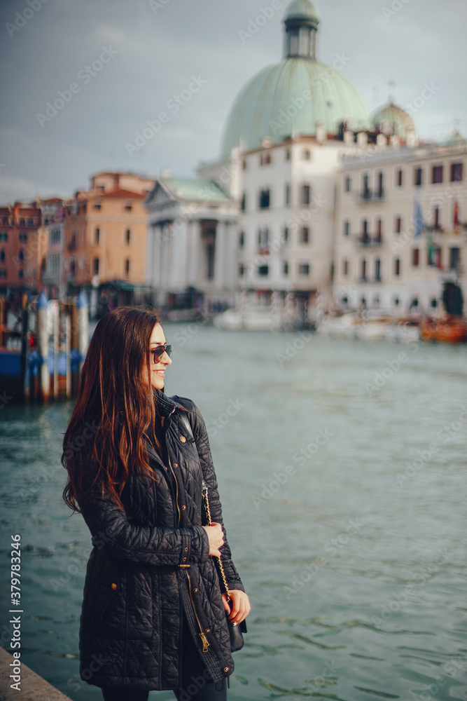 female tourist walking around and exploring venice in the early spring
