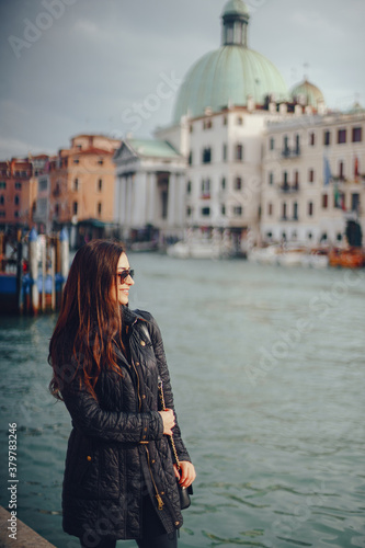 female tourist walking around and exploring venice in the early spring