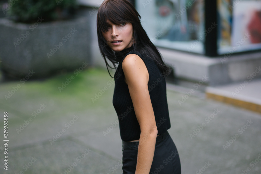 A brunette walking and looking back A brunette walking and looking back