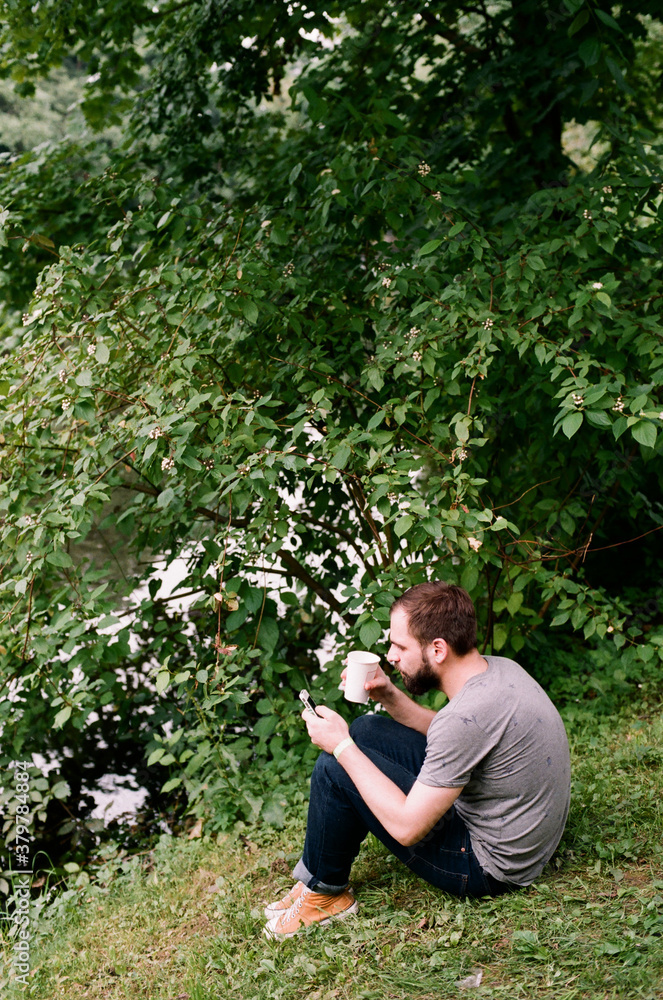 Man checking his phone outdoors Man checking his phone outdoors