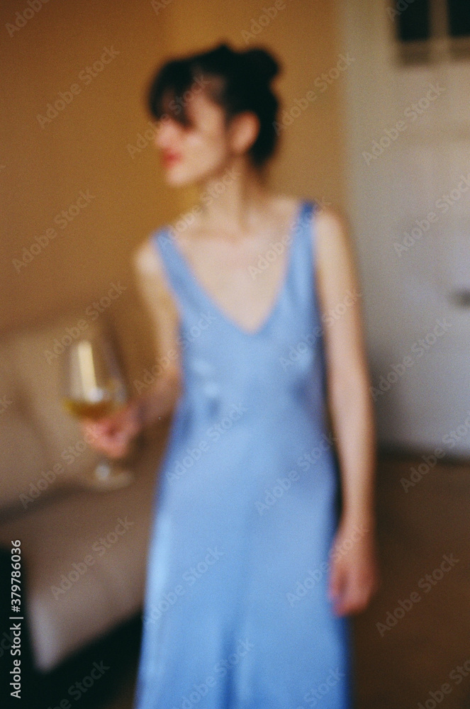 Out-of-focus shot of woman with a glass of wine Out-of-focus shot of woman with a glass of wine