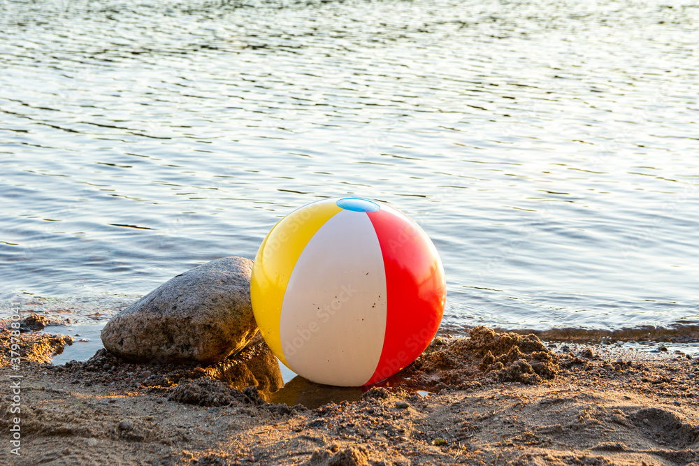 Inflatable beach ball on the shore of The Lake Saimaa, Ukonlinna beach, Imatra, Finland Inflatable beach ball on the shore of The Lake Saimaa, Ukonlinna beach, Imatra, Finland