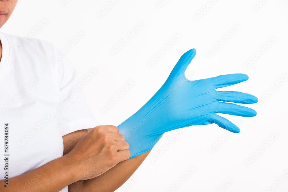 Woman wearing and putting hand to blue rubber latex glove