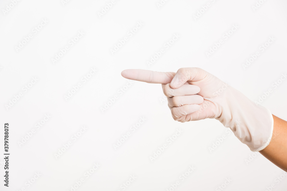 Woman wearing hand to rubber medical glove with point finger Woman wearing hand to rubber medical glove with point finger