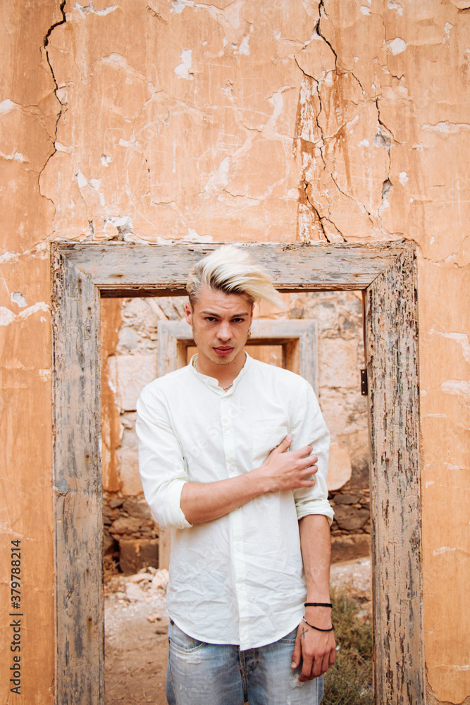 Portrait of young man on a wall with a door frame Portrait of young man on a wall with a door frame