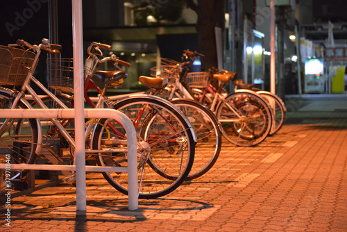 Bicycle parking in Japan at night.