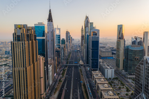 Morning rush hour traffic, metro trains and modern skyscrapers on Sheikh Zayed Road during sunrise