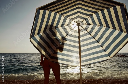 Handsome silhouette in the front of the umbrella