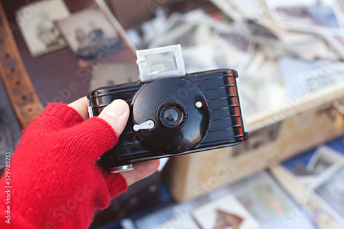 hand holding an old cameras for sale at a flea market