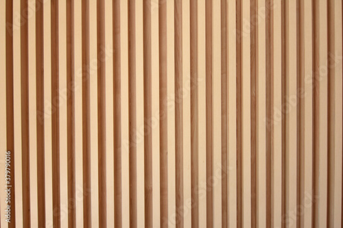 Light brown slats of wood. Lines of wooden slats form a striped texture pattern. Line shaped wood texture