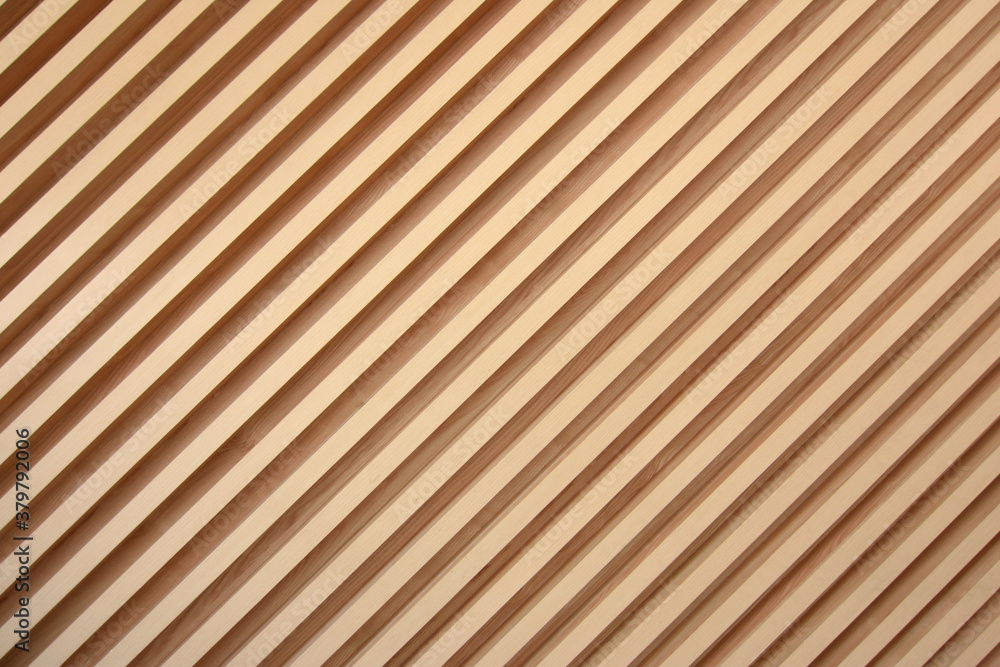 Light brown slats of wood. Lines of wooden slats form a striped texture