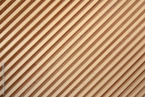 Light brown slats of wood. Lines of wooden slats form a striped texture pattern. Line shaped wood texture