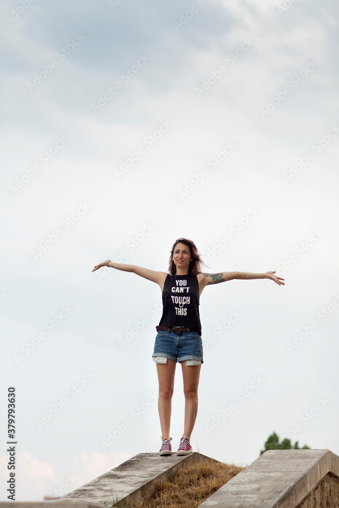 Woman standing on a stairs with spread hands Woman standing on a stairs with spread hands