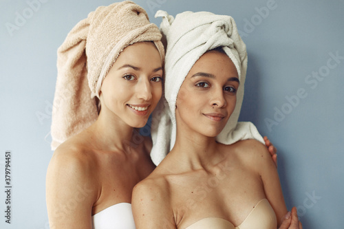 Girls in a studio. Ladies on a blue background. Women in a towel