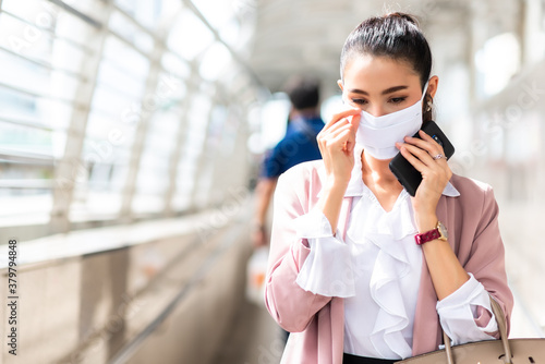 Woman on pink blazer suit wearing face mask in the morning