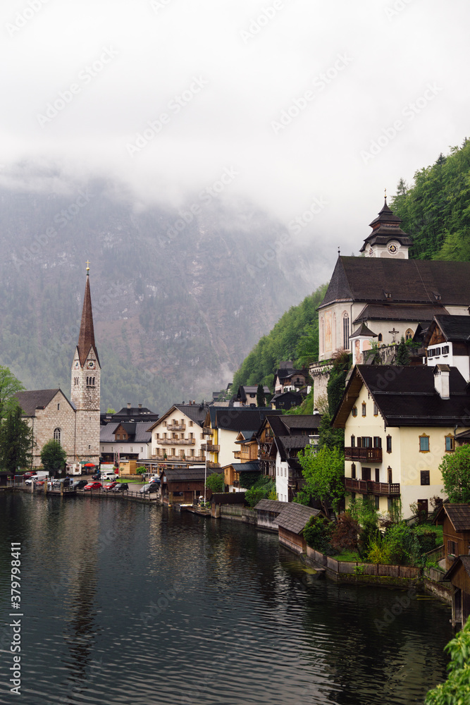 Foggy morning in Austrian village at mountain lake Foggy morning in Austrian village at mountain lake