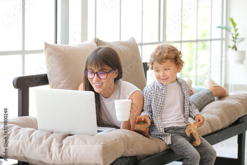 Young mother and son using ...