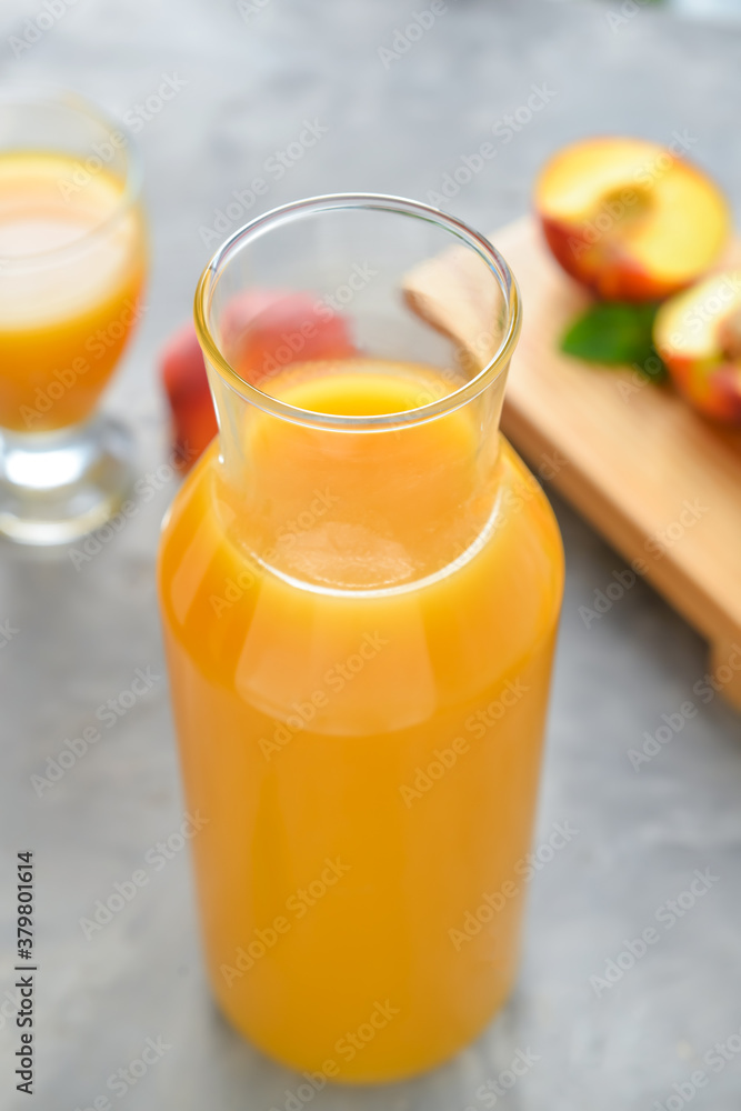 Bottle of fresh peach juice on table Bottle of fresh peach juice on table