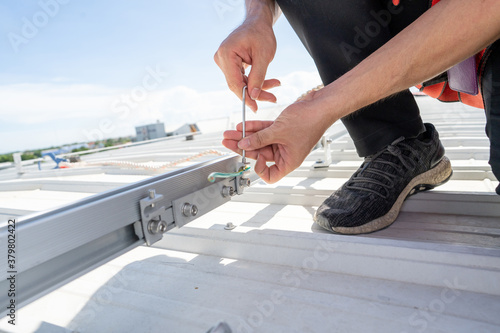 installing grounding in steel bar of solar rooftop power system by barehanded stock photo photo